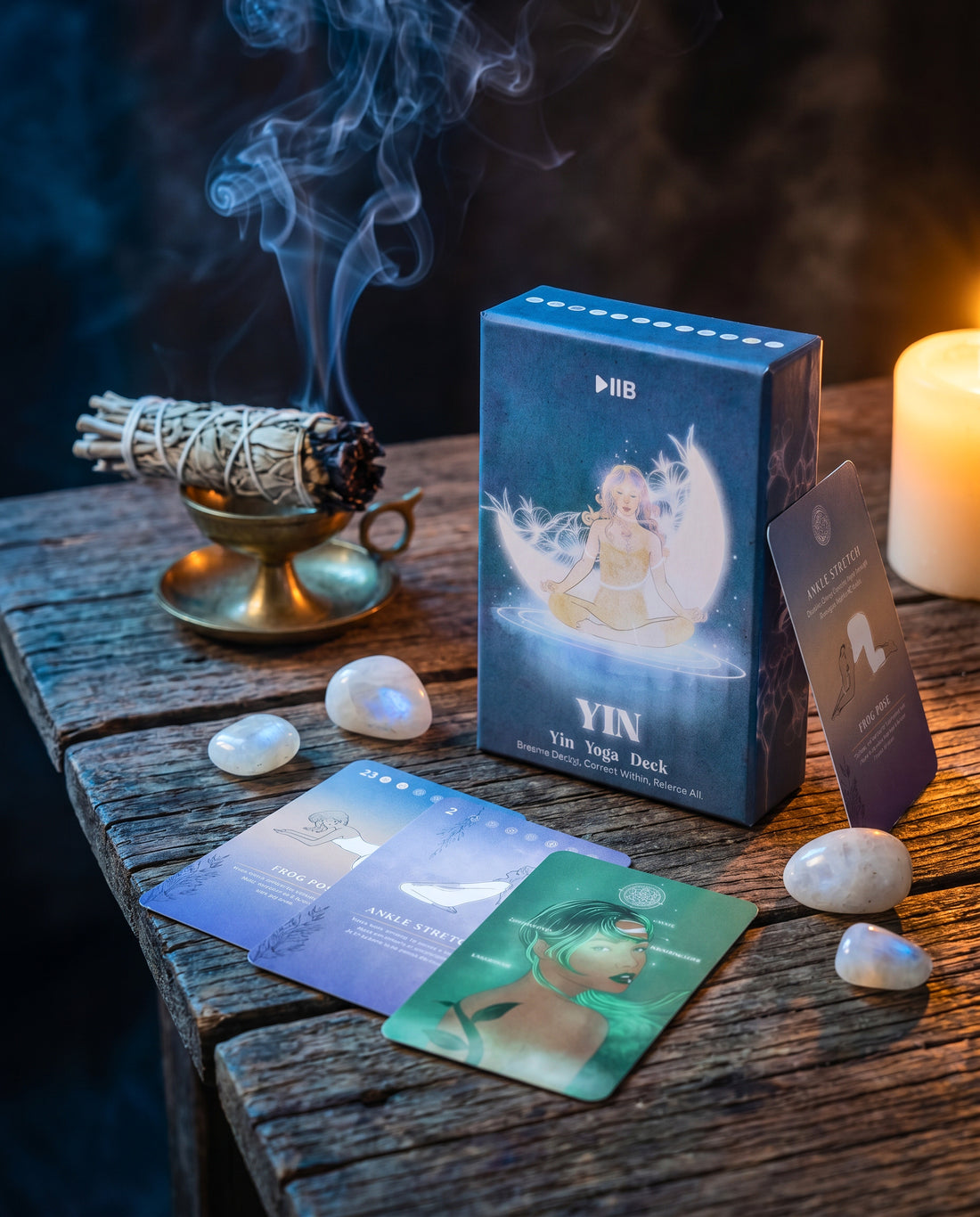 The Yin Yoga Deck box on a wooden table with moonstones, candlelight and smouldering sage