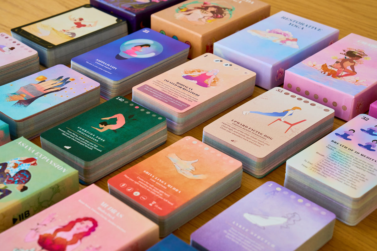 Decks and cards from every style laid out in rows on a wooden table