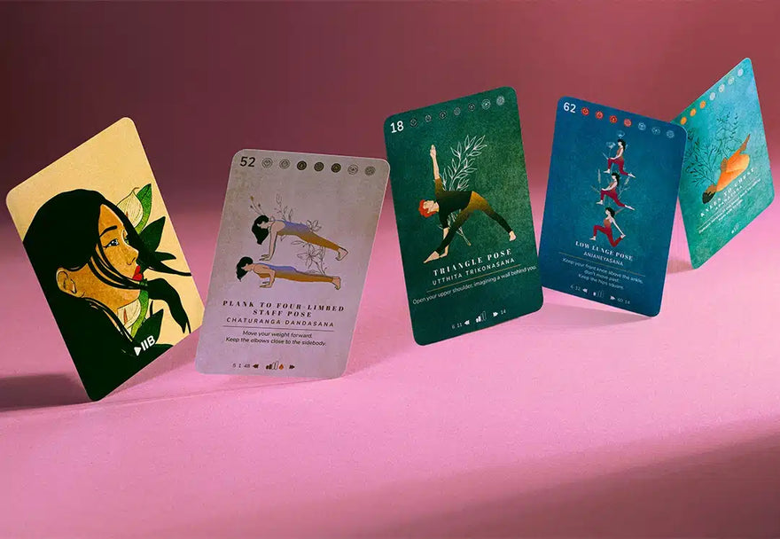 Hands holding a fan of Yoga Deck cards hand-illustrated by Giulia Rosa
