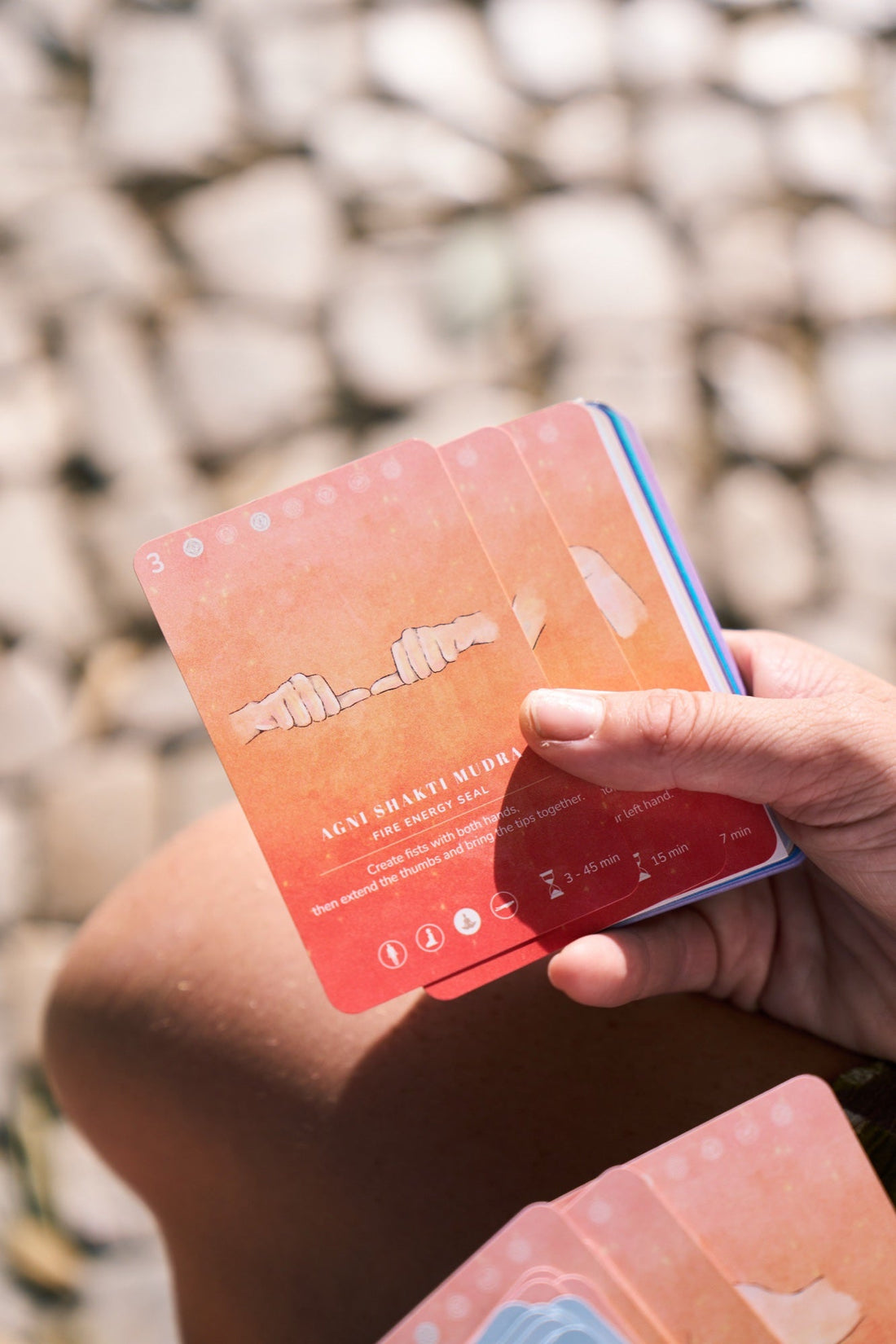 Holding a few mudra cards outdoors