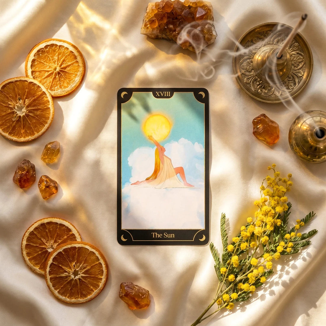 The Sun card laid out with citrine, dried orange and mimosa